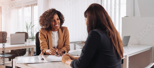 Woman consulting with a female financial manager at the bank
