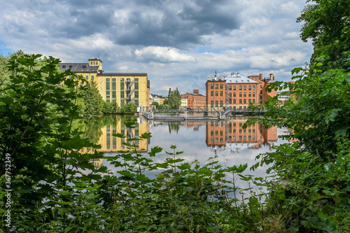 The old industrial landscape and Motala river during summer. Norrkoping is a historic industrial town in Sweden famous for its textile mills which closed long ago.