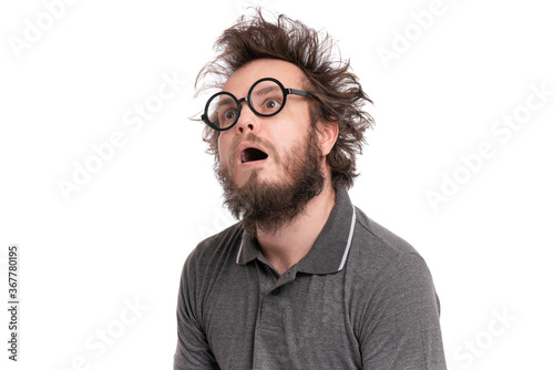 Crazy Scared or Shocked Bearded Man with funny Haircut in Eyeglasses looks Worried. Silly, Afraid or Surprised guy, isolated on white background.