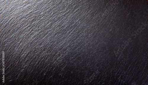 Black stone and slate textured wall closeup