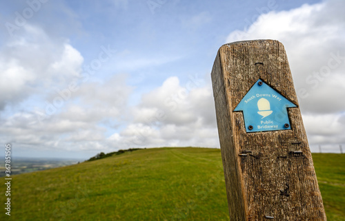 South Downs National Park, Sussex, UK near Firle Beacon. A signpost shows the route of the South Downs Way towards Firle Beacon. The South Downs Way is a national trail popular with walkers.
