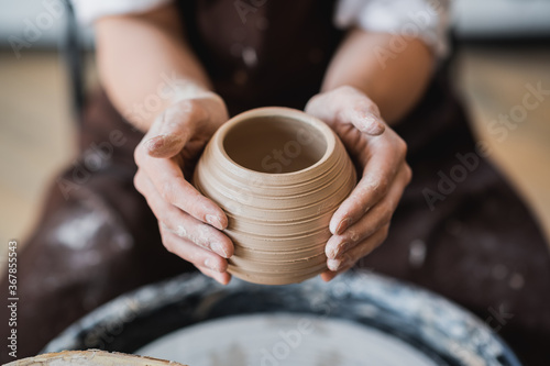 Master class on modeling of clay on a potter wheel In the pottery workshop