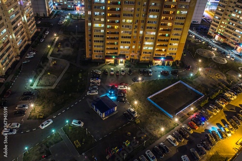 View from the roof of Ulyanovsk residential district at night. Blocks of flats, streets, roads and cars parkings. Russia.