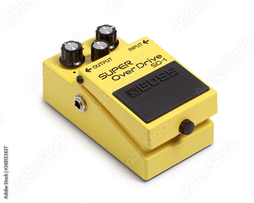 Bangkok, Thailand - July 15, 2020: Boss electric guitar effects pedals model super overdrive SD-1. Stomp box electric guitar signal over drive yellow effects foot pedal isolated on white background.