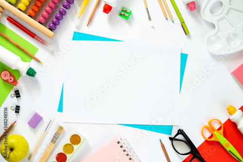 Colorful school background with blank sheet of paper. Back to school. Flat lay.