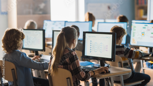 Elementary School Science Classroom: Teacher Educates Smart Little Schoolchildren who Work on Computers, Learn Programming Language for Software Coding. Schoolchildren Getting Modern Education