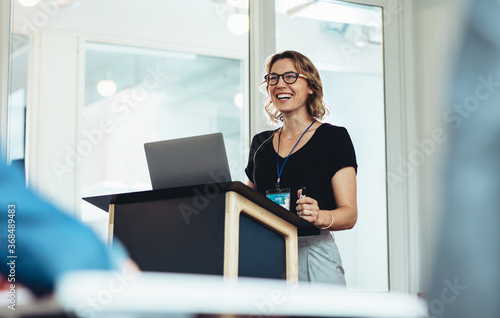 Female business professional addressing a seminar