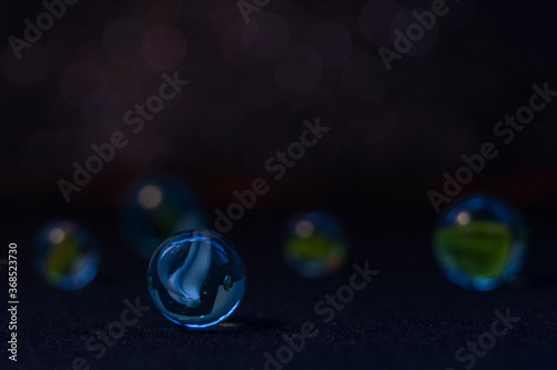 Blue glass ball on a dark blue background