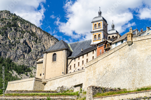 The Collegiate Church of Notre-Dame and Saint-Nicolas overlooking Briancon city walls, Huates Alpes, France