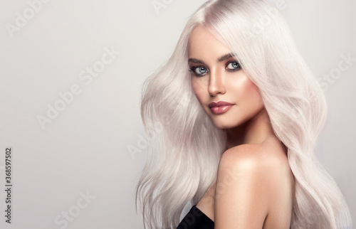  Beautiful girls with hair coloring in blond. Straight and smooth hair coloring in ultra blond color in a beauty salon. Beauty, cosmetics and makeup