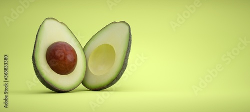 Avocado cut in half on green background.