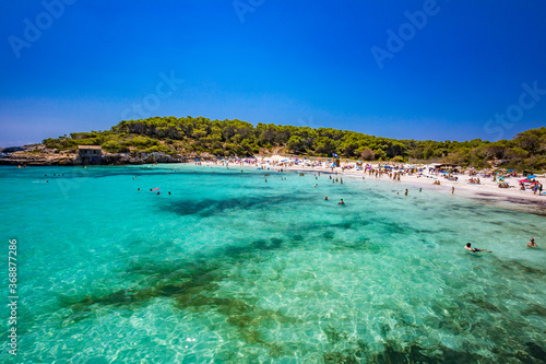 CALA MONDRAGO, Majorka, Spain, 24 July 2020 - People enjoy the beach in summer, Parque Natural de Mondrago. Santanyi. Malorca. Spain