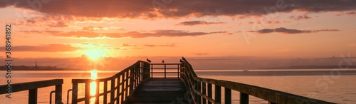 scenic sunrise with pier by the sea, panorama