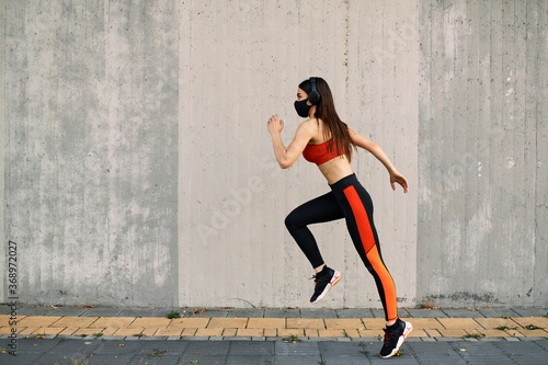 Woman running wearing mask for protection