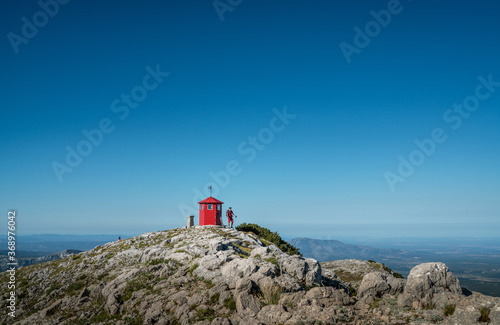 Young backpacker man with trekking poles climbing Sinjal or Dinara 1831 m mountain - the highest of Croatia in the Dinaric Alps on the border between the Republic of Croatia and Bosnia and Herzegovina