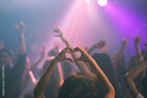 Party with friends dancing in the club. asian event holidays celebrate nightlife. Group of young girl happy dancing party hand holding a drink. Lady with shape heart in event concert