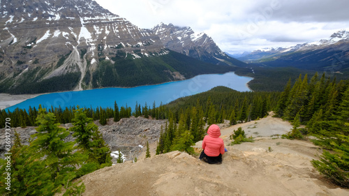 Tourist enjoys a beautiful mountain lake. Peyto Lake, Canadian Rockies, Banff, Alberta, Canada