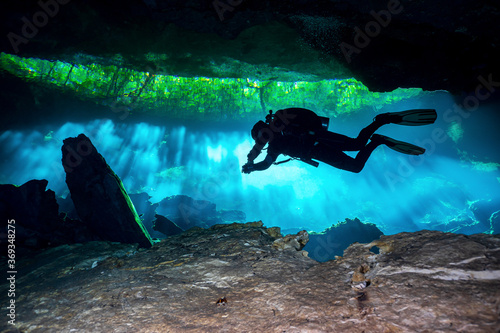 Scuba Divers in a Cenote deep in the Jungle of Mexico