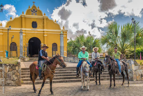 4 men on horseback in front of The Church of San Pedro, In the center of Diria, a small town near Granada Nicaragua 