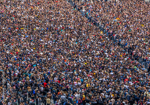 large crowd of people at a rock concert selective focus, blurred image