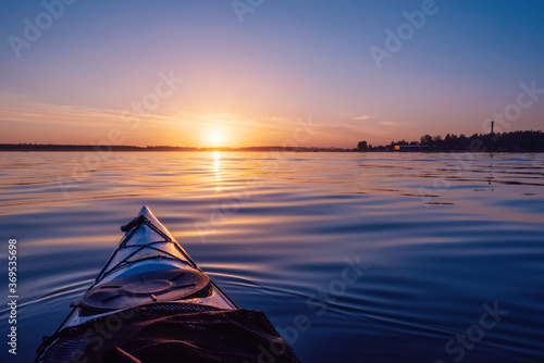 Sunset sky on the lake. View from the kayak