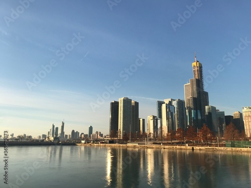 Downtown Chicago skyline with reflections on the Michigan lake. Early morning. Chicago, Illinois, United States.