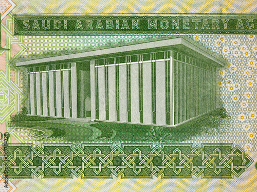 Saudi Arabia one riyal banknote macro, Saudi Arabian Monetary Agency headquarters building, money closeup