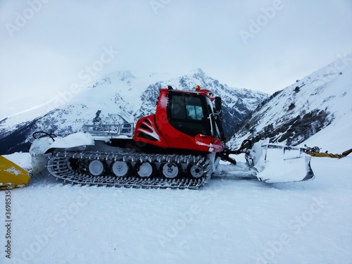 Beautiful modern tracked snowplow tractor in the mountains