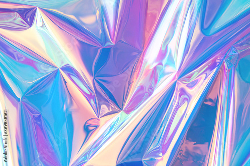 Blurred abstract Modern pastel colored holographic background in 80s style. Crumpled iridescent foil real texture. Synthwave. Vaporwave style. Retrowave, retro futurism, webpunk