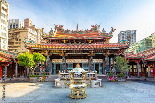 Lungshan Temple in Taipei,Taiwan. The Chinese text is "Protect the people", "Grace and fertility" and "Grace illuminates all creatures". The Chinese text on incense burner is "Guanyin Buddha".