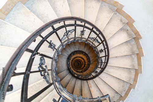 Spiral stone staircase with metal railings. St. Stephen's Basilica.