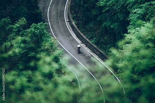 solo cyclist on the road in mountain 