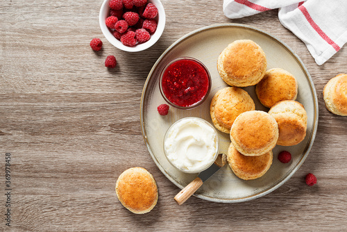 Scones with raspberry jam and clotted cream. 