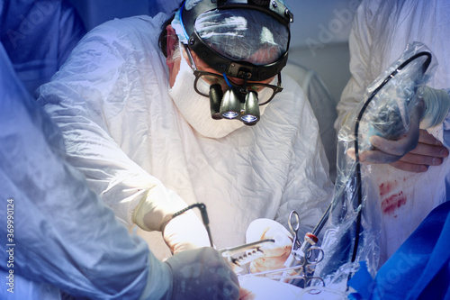 A surgical team operates on a patient in a hospital