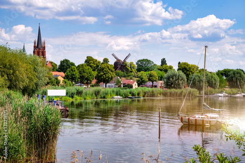 Colorful sailboat in front of a little river island, witch is part of the town Werder, Havel