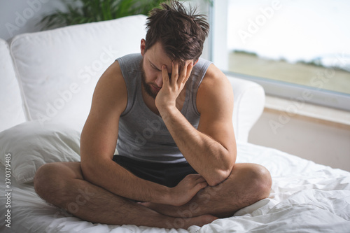 Worried man in bed