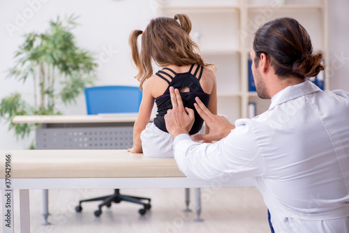 Small girl visiting young male doctor