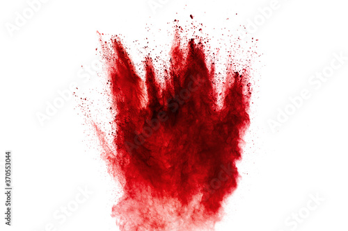 Red dust particles explosion on white background.Red sand splash.