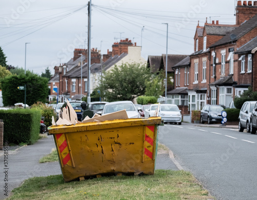 Full domestic skip on village road