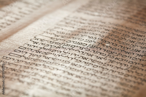 Ancient and precious Torah scroll, closeup on writing