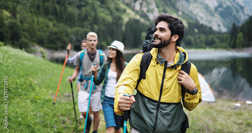 Group of friends hiking together outdoors exploring the wilderness and having fun