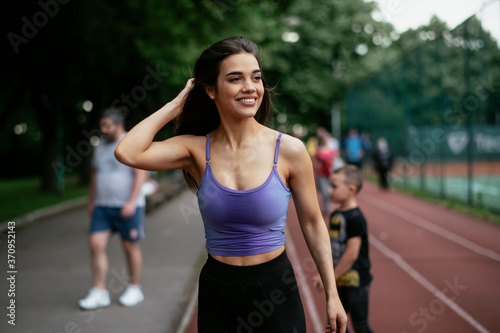 Happy athletic woman running in nature in the morning. Young woman training outdoors.