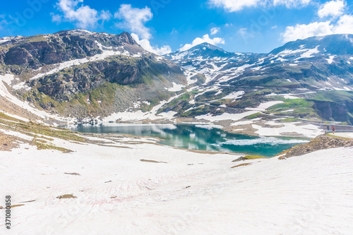 Beautiful emerald Alpine Lake in the snowy landscape in Gran Paradiso National Park Italy