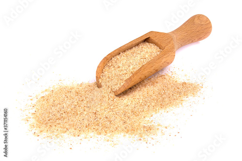 Pile of breadcrumbs and spoon isolated on white