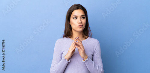 Young caucasian woman over isolated background scheming something