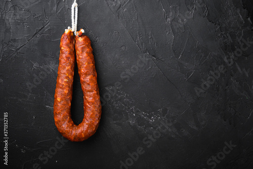 Spanish pork chorizo sausages on black background with space for text
