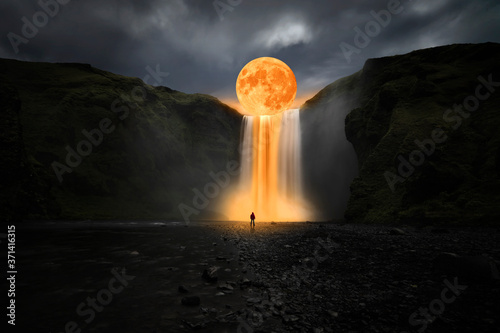 Orange moon over great waterfall