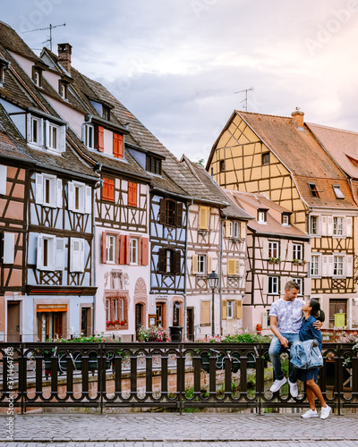 couple on city trip Colmar, Alsace, France. Petite Venice, water canal and traditional half timbered houses. Colmar is a charming town in Alsace, France. Beautiful view of colorful romantic city