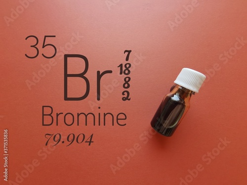 Bromine is a chemical element of the periodic table with the symbol Br and atomic number 35. The symbol Br with atomic data and reddish-brown liquid bromine solution in a glass reagent bottle.