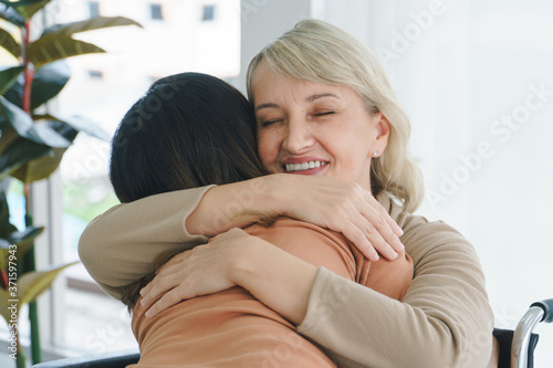 Grandma hugs granddaughter and smiling happily